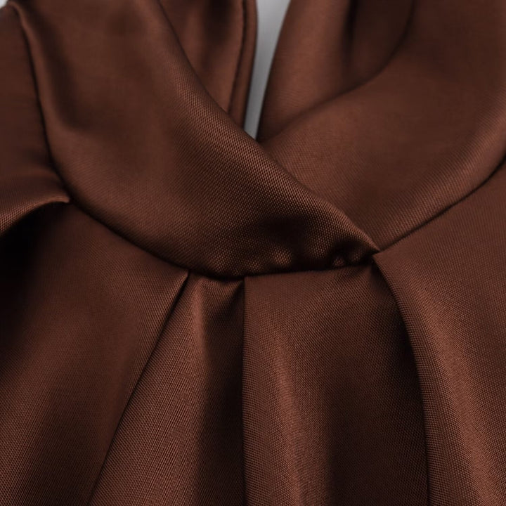 Close-up of brown fabric with a bow