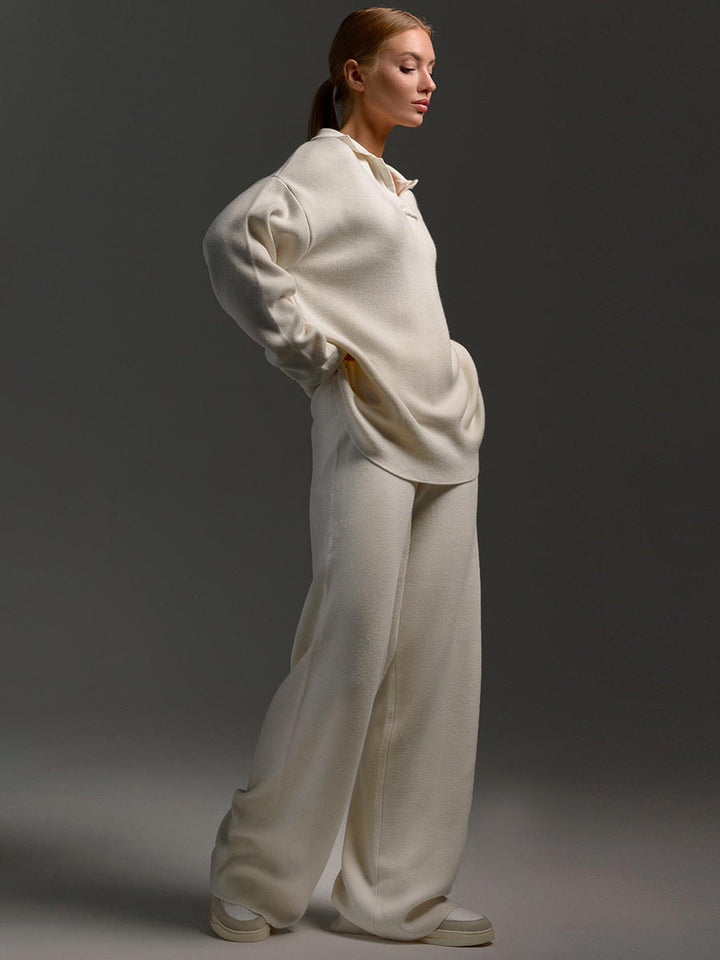 Person wearing a white outfit against a dark background