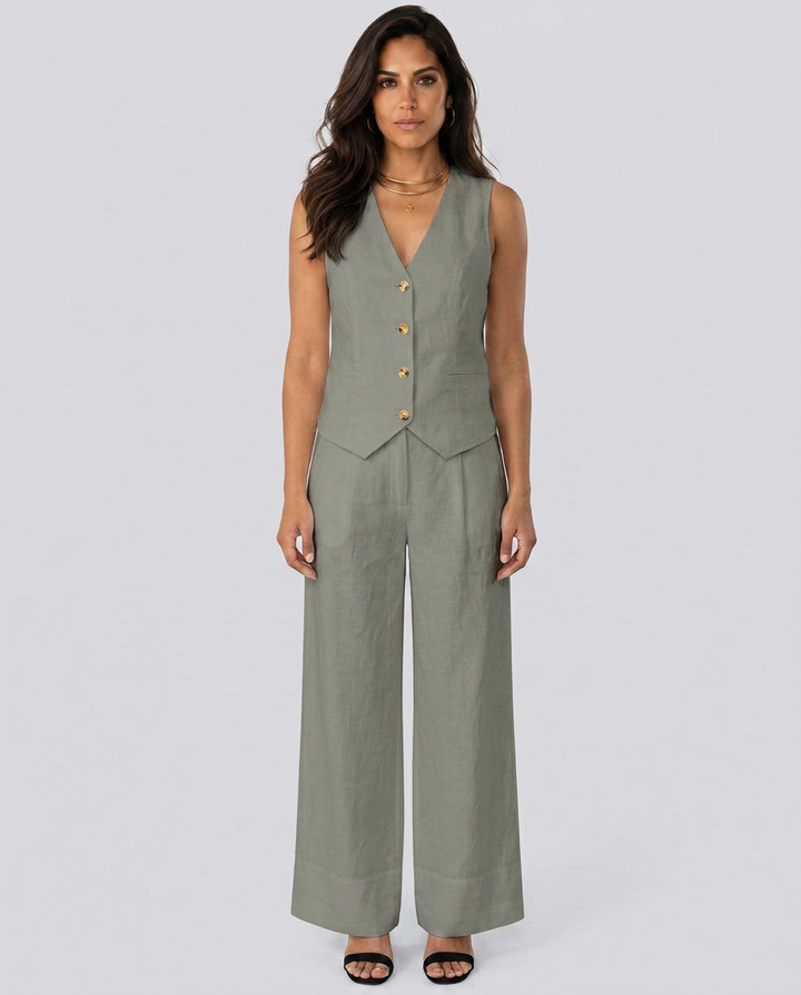 Woman wearing a green vest and wide-leg pants on a white background