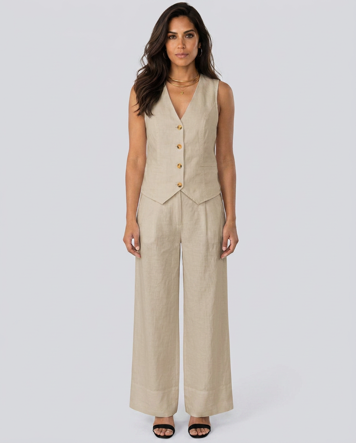 Woman wearing a beige vest and wide-leg pants on a white background