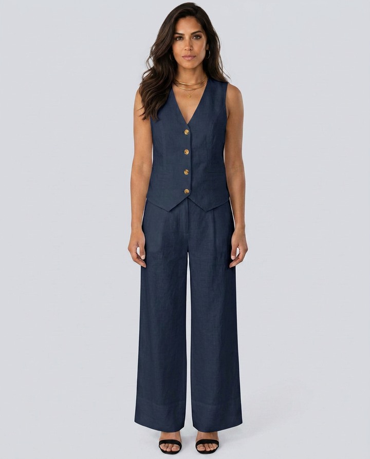 Woman wearing a navy blue vest and wide-leg pants on a white background