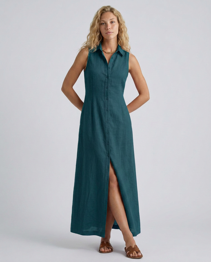 Woman wearing a teal sleeveless dress with a slit on a white background