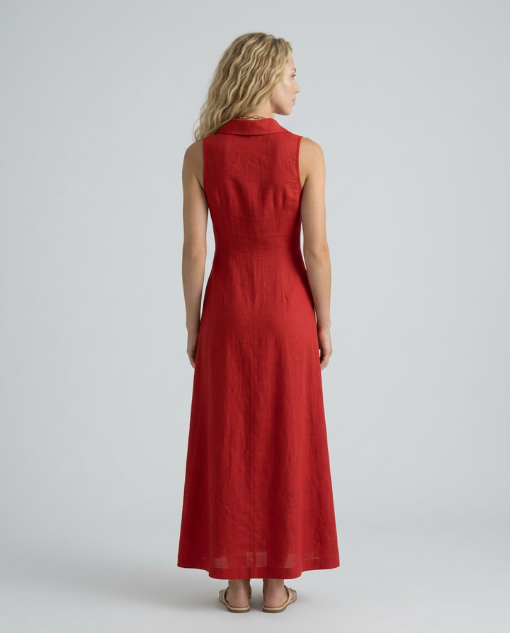 Woman wearing a red dress on a plain background