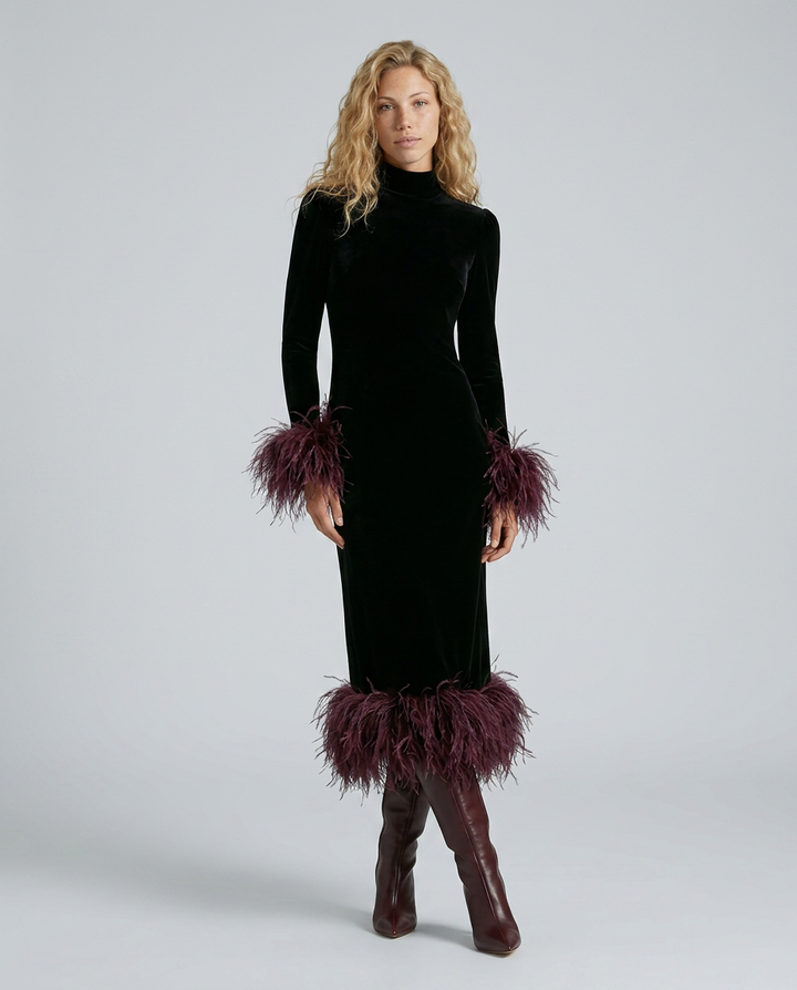 Woman wearing a black dress with feathered details on a gray background