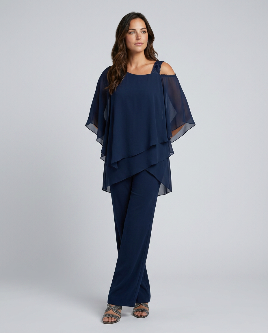 Woman wearing a navy blue outfit with a layered top and wide-leg pants on a white background
