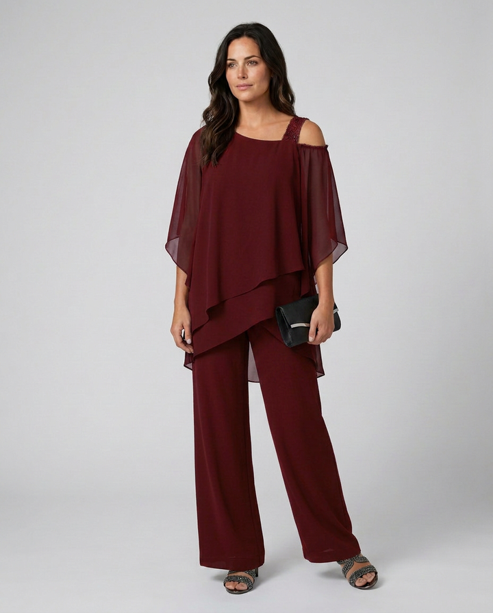 Woman wearing a burgundy outfit with a plain background