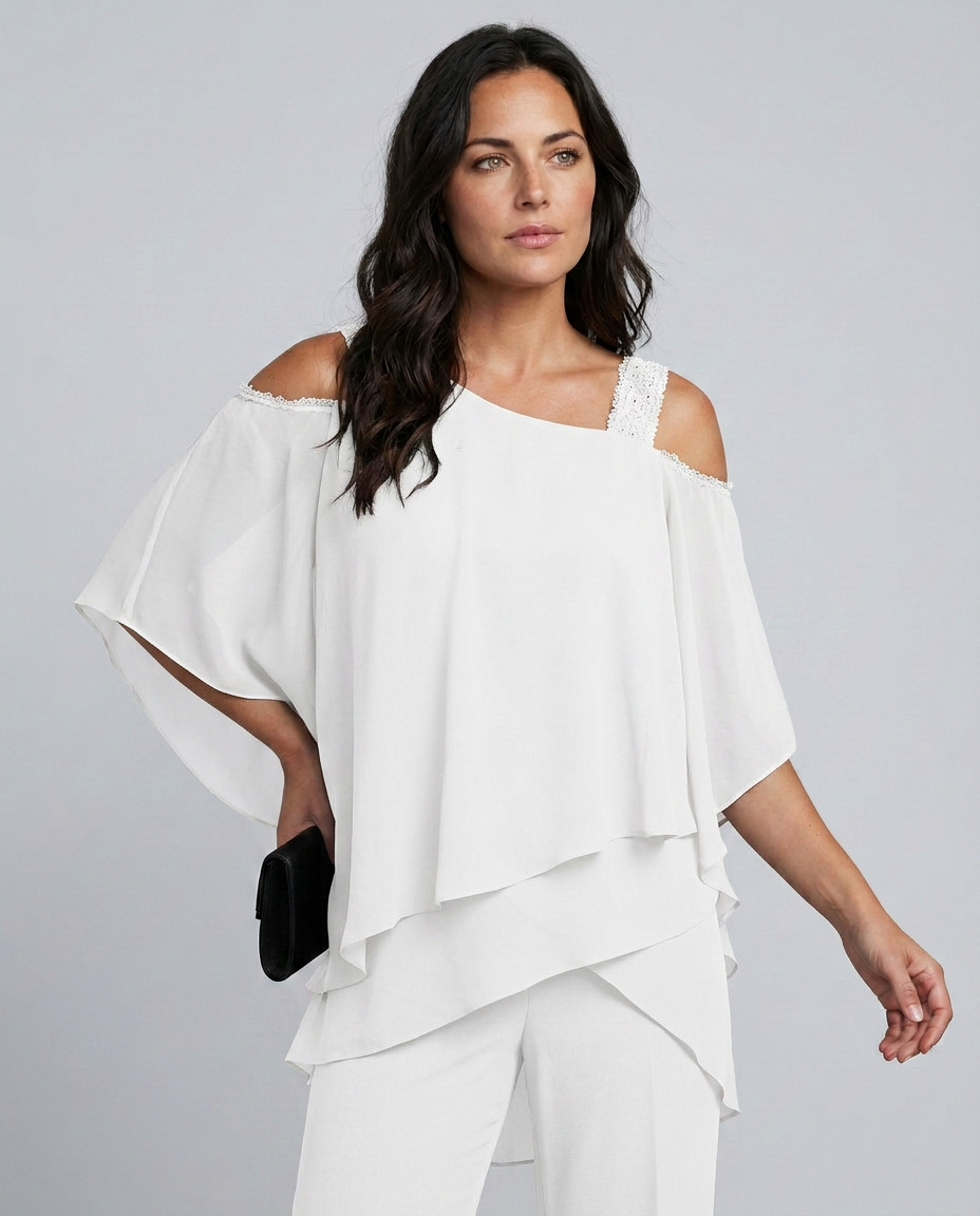 Woman wearing a white off-shoulder top and pants against a gray background