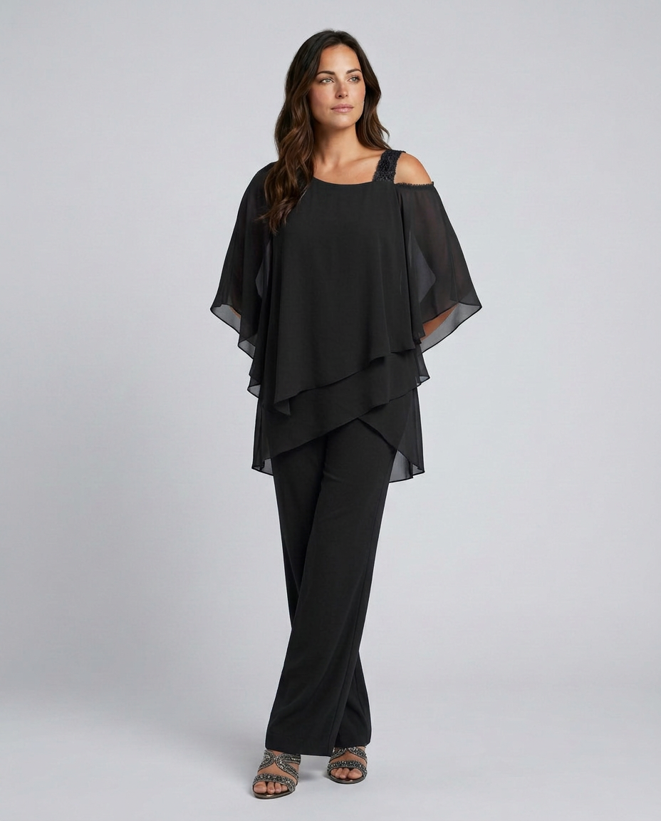 Woman wearing a black outfit with a layered top and wide-leg pants on a white background