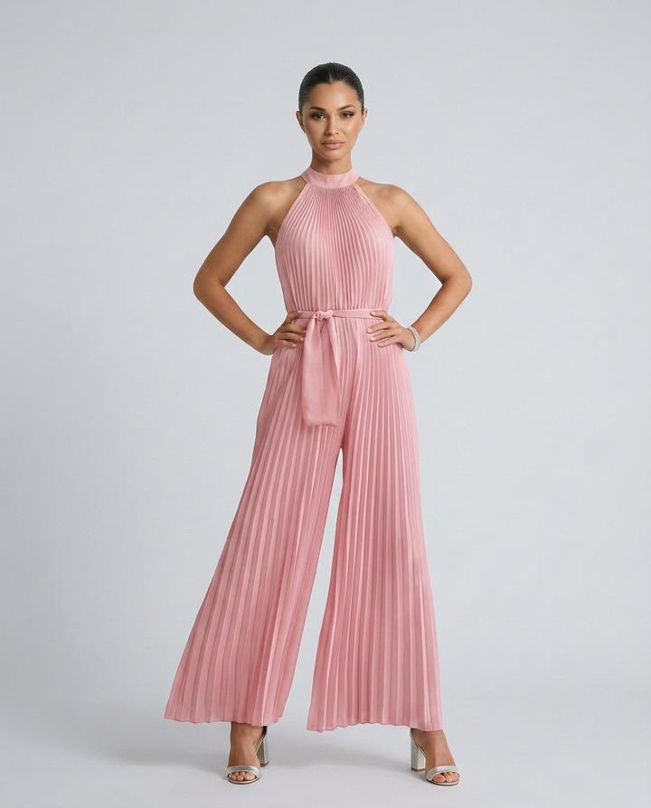 Woman wearing a pink pleated jumpsuit on a white background