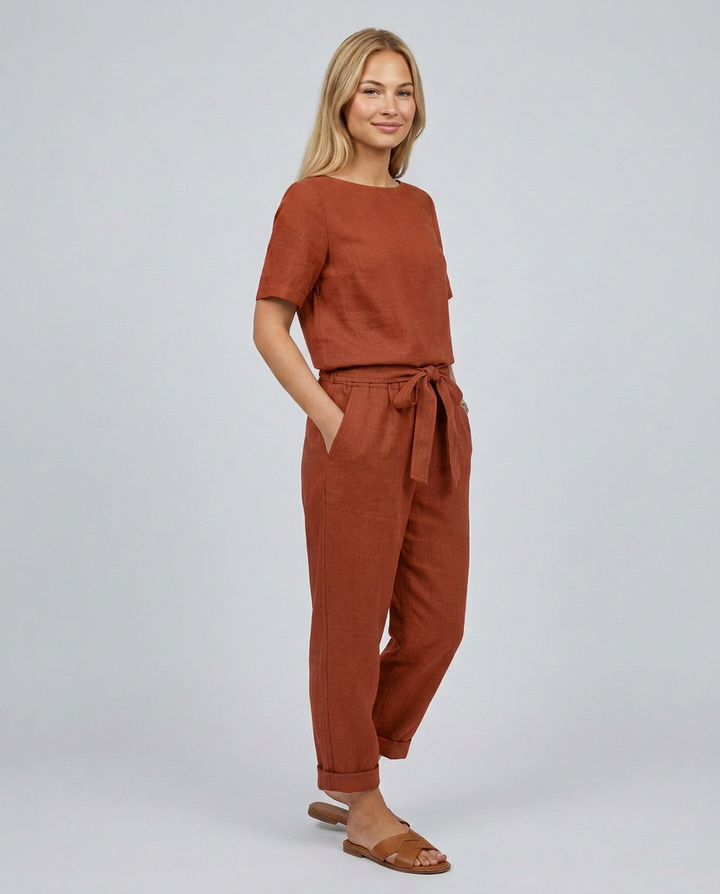 Woman wearing a brown outfit on a plain background