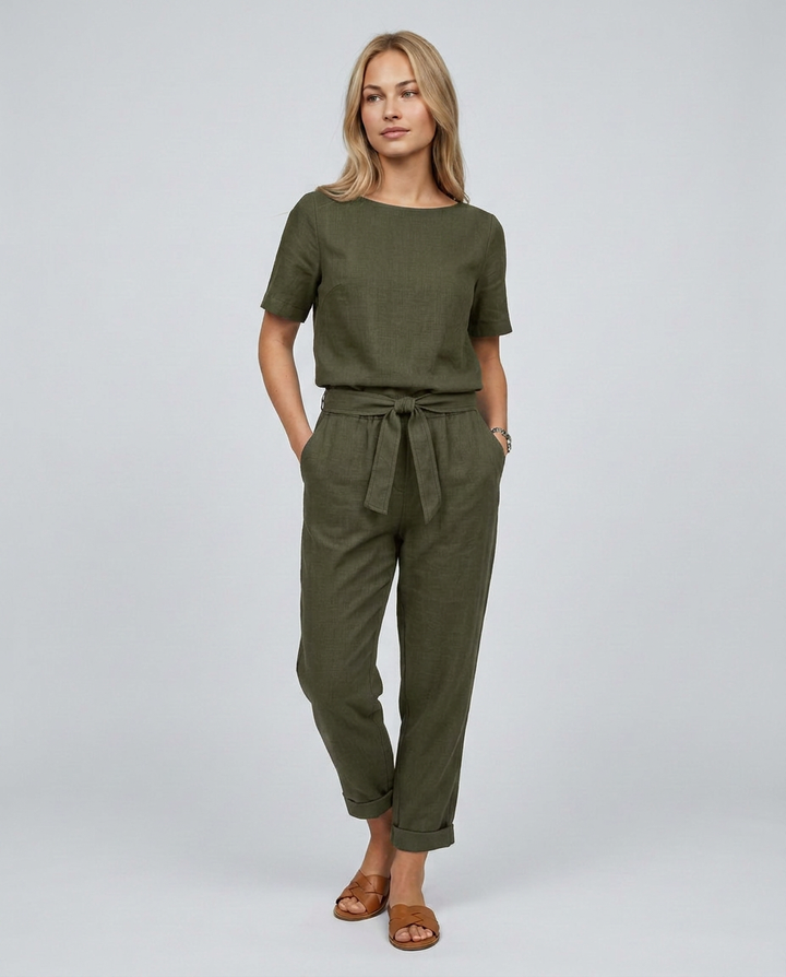Woman wearing an olive green jumpsuit on a white background