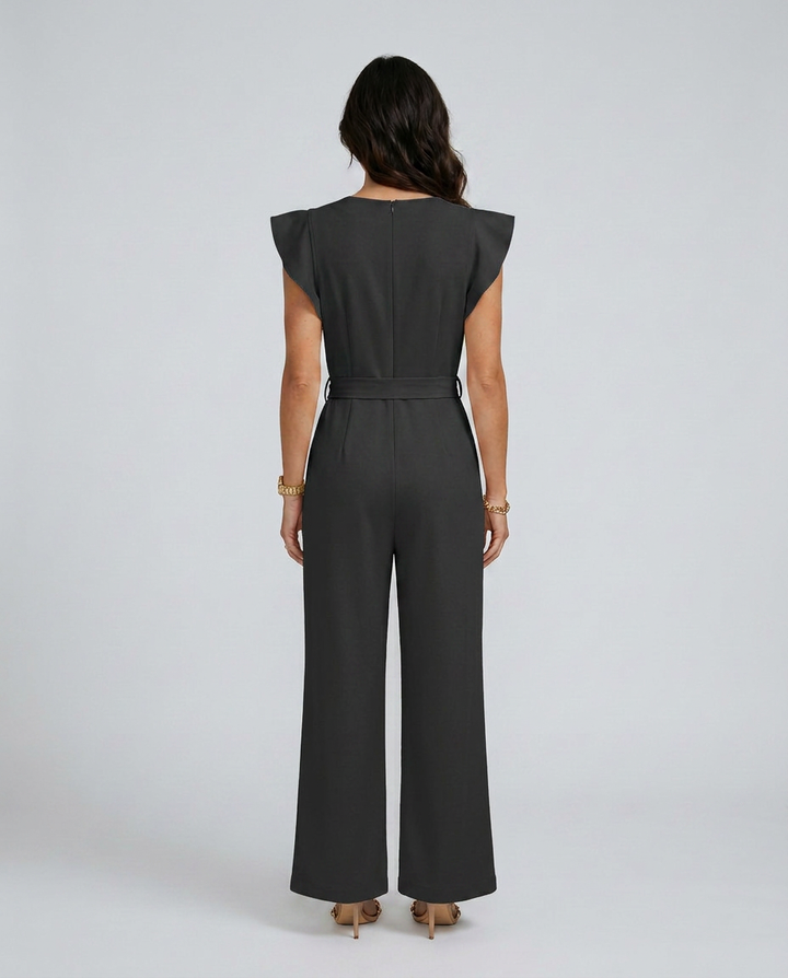 Woman wearing a black jumpsuit on a white background