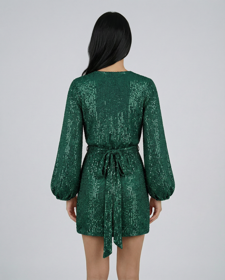 Green sequin dress worn by a person on a gray background