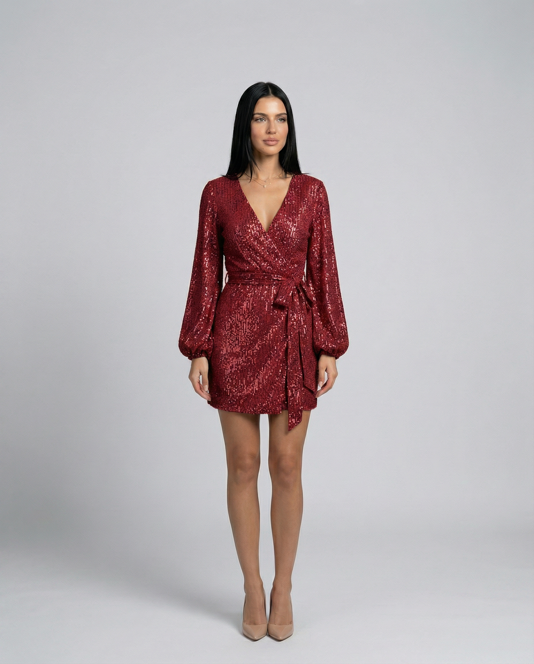 Woman wearing a red sequin dress on a gray background