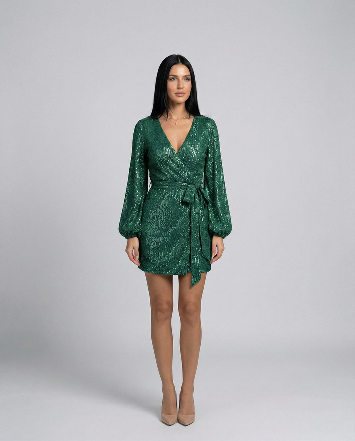 Woman wearing a green sequin dress on a gray background