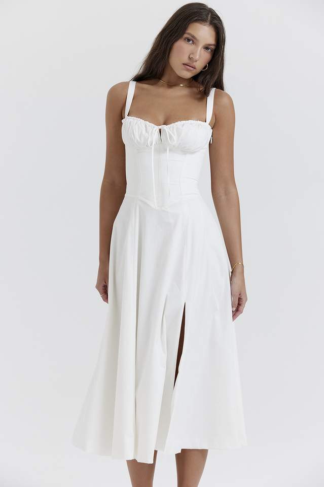 Woman wearing a white dress with thin straps on a white background