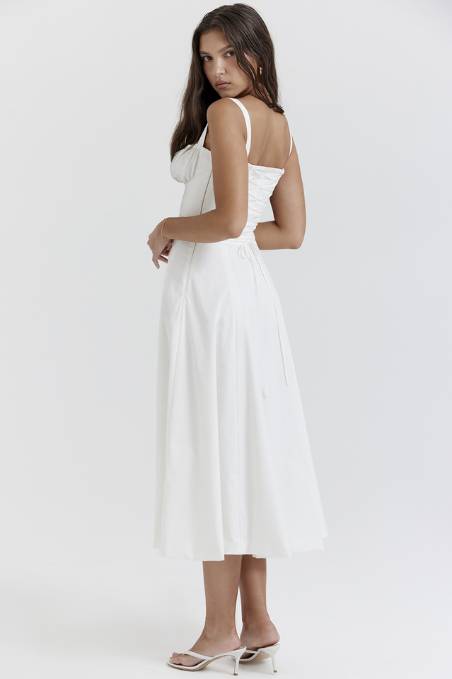 Woman wearing a white dress on a plain background
