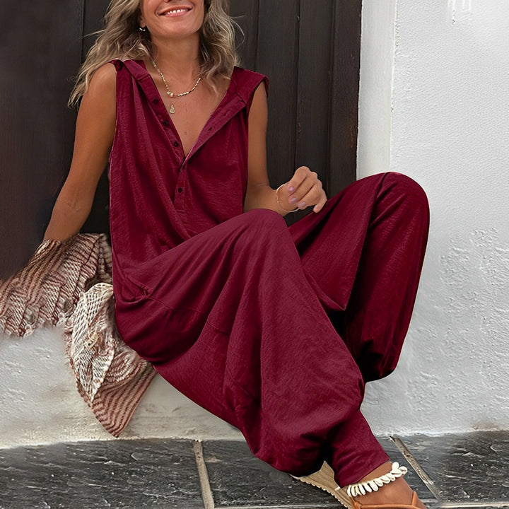 Woman wearing a burgundy outfit sitting on steps.