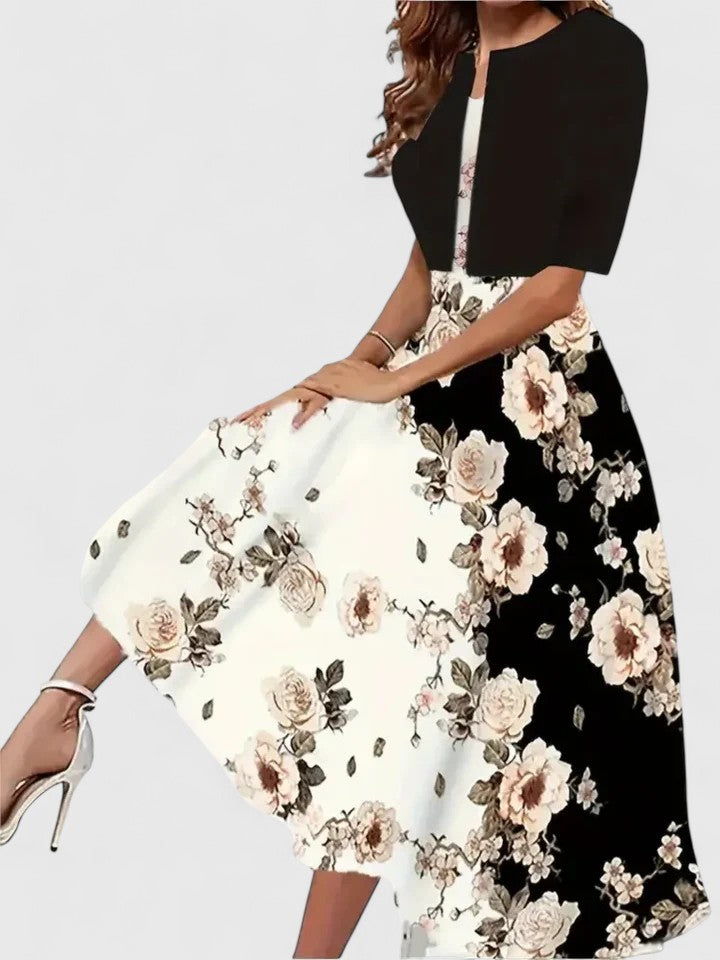 Two dresses with floral patterns, one white and one black, on a plain background.