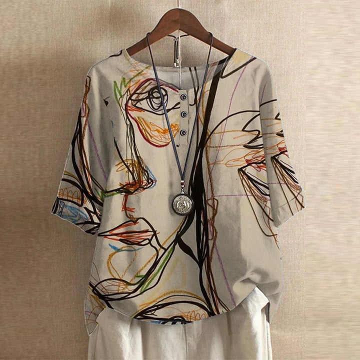 Colorful abstract patterned shirt on a hanger against a beige wall
