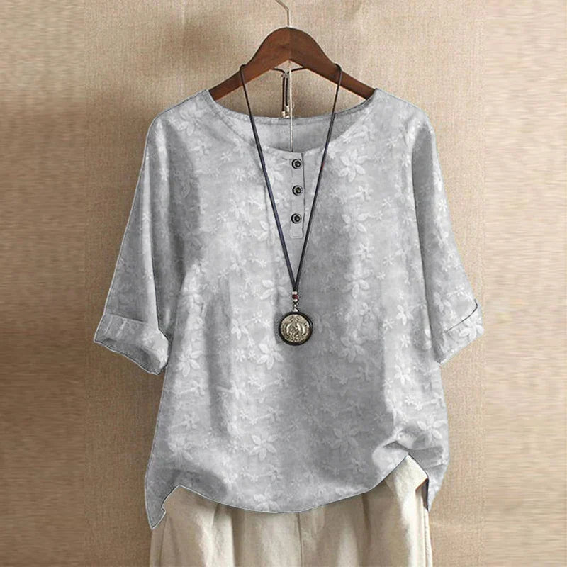 Gray shirt on a hanger with a beige background