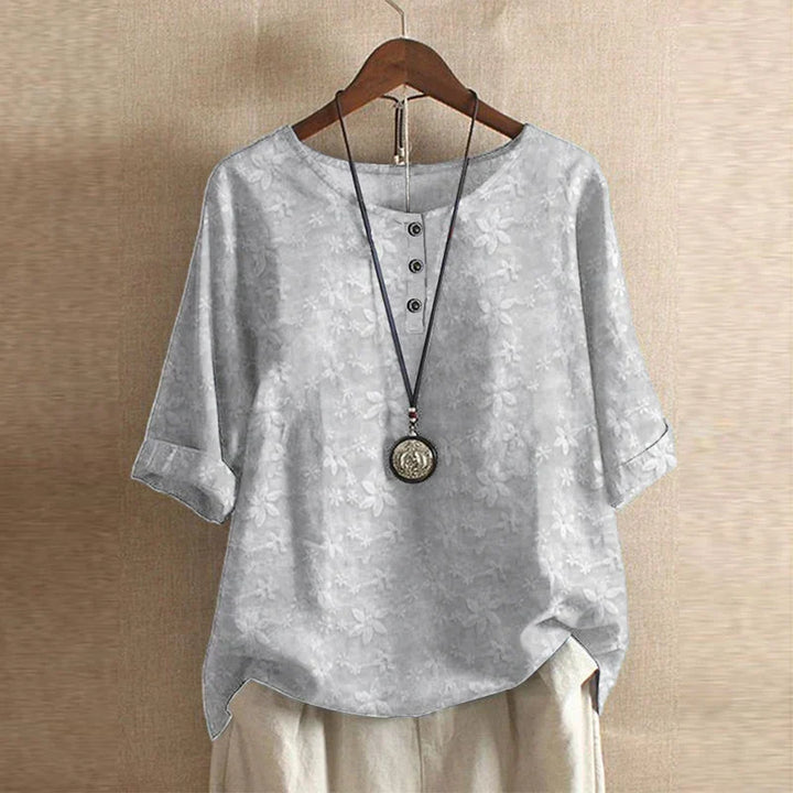 Gray shirt on a hanger with a beige background