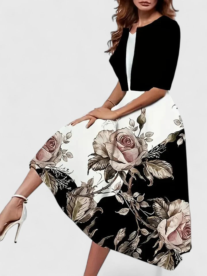Woman wearing a black floral dress with a white background