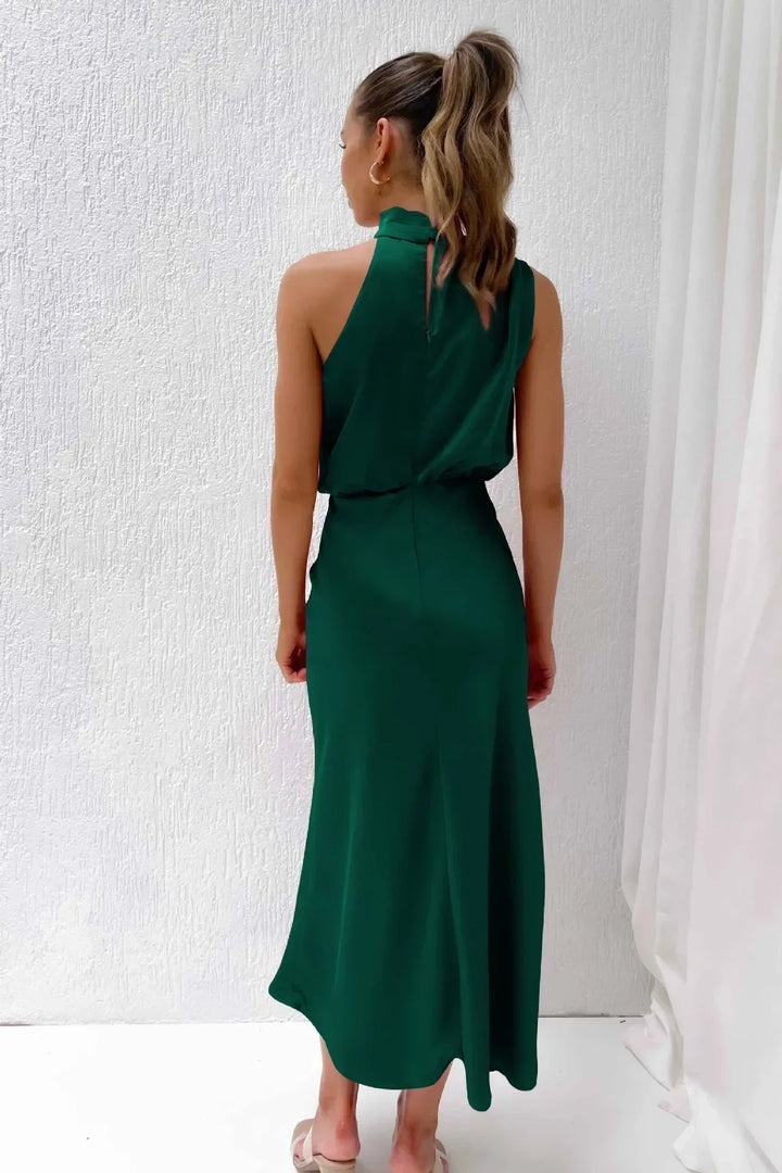Woman wearing a green dress against a white background