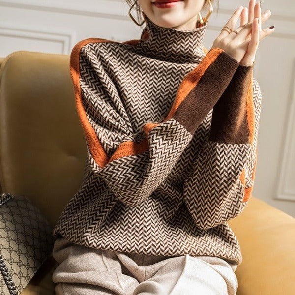 Person wearing a patterned sweater sitting on a couch.