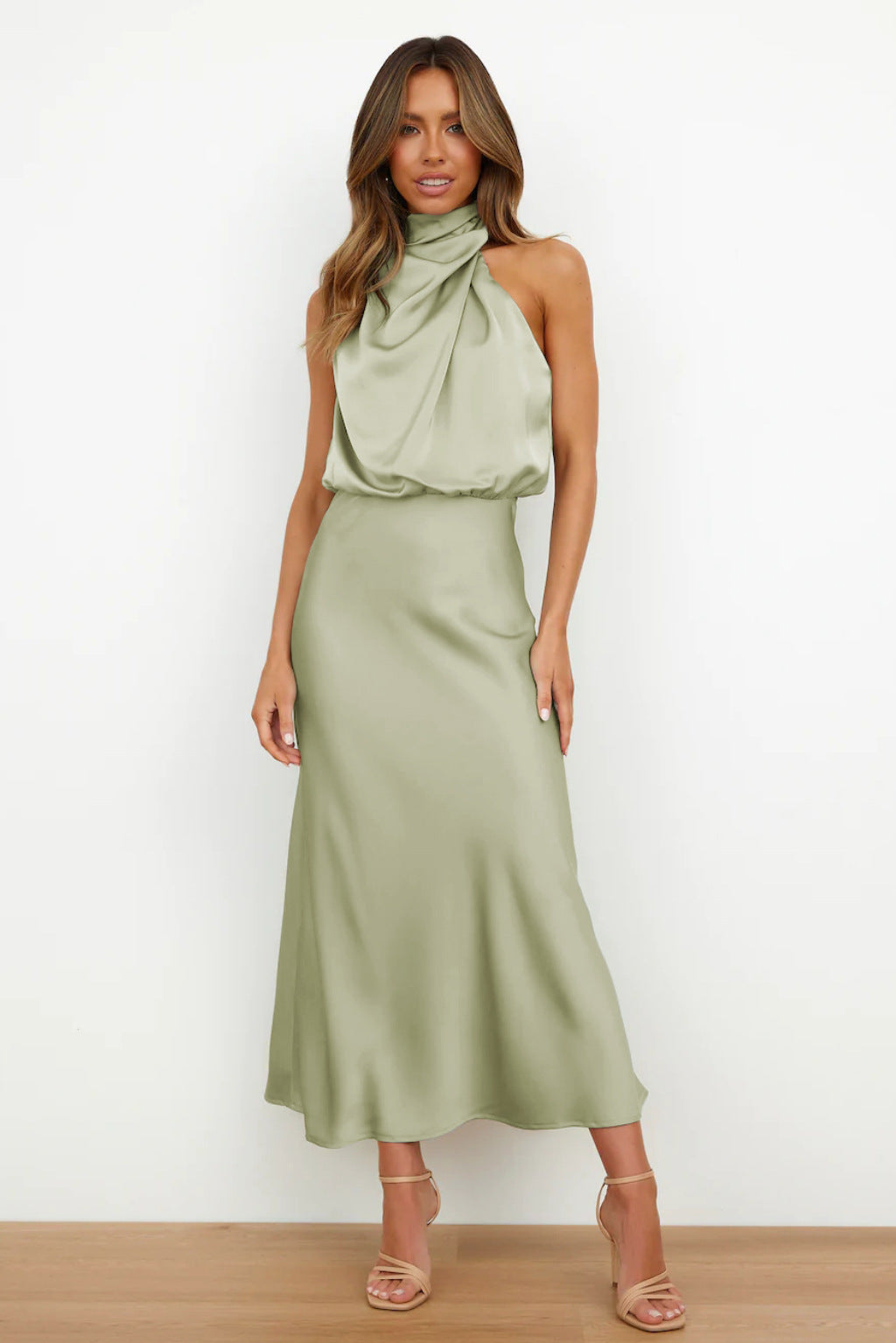 Woman wearing a green dress with a white background