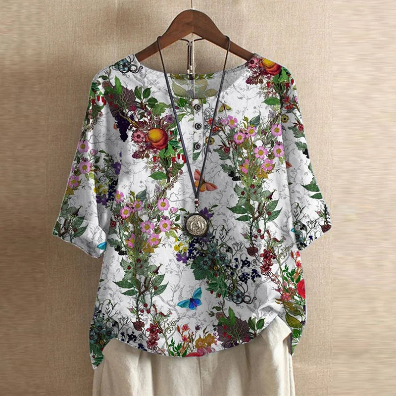 Floral patterned blouse on a hanger against a beige background