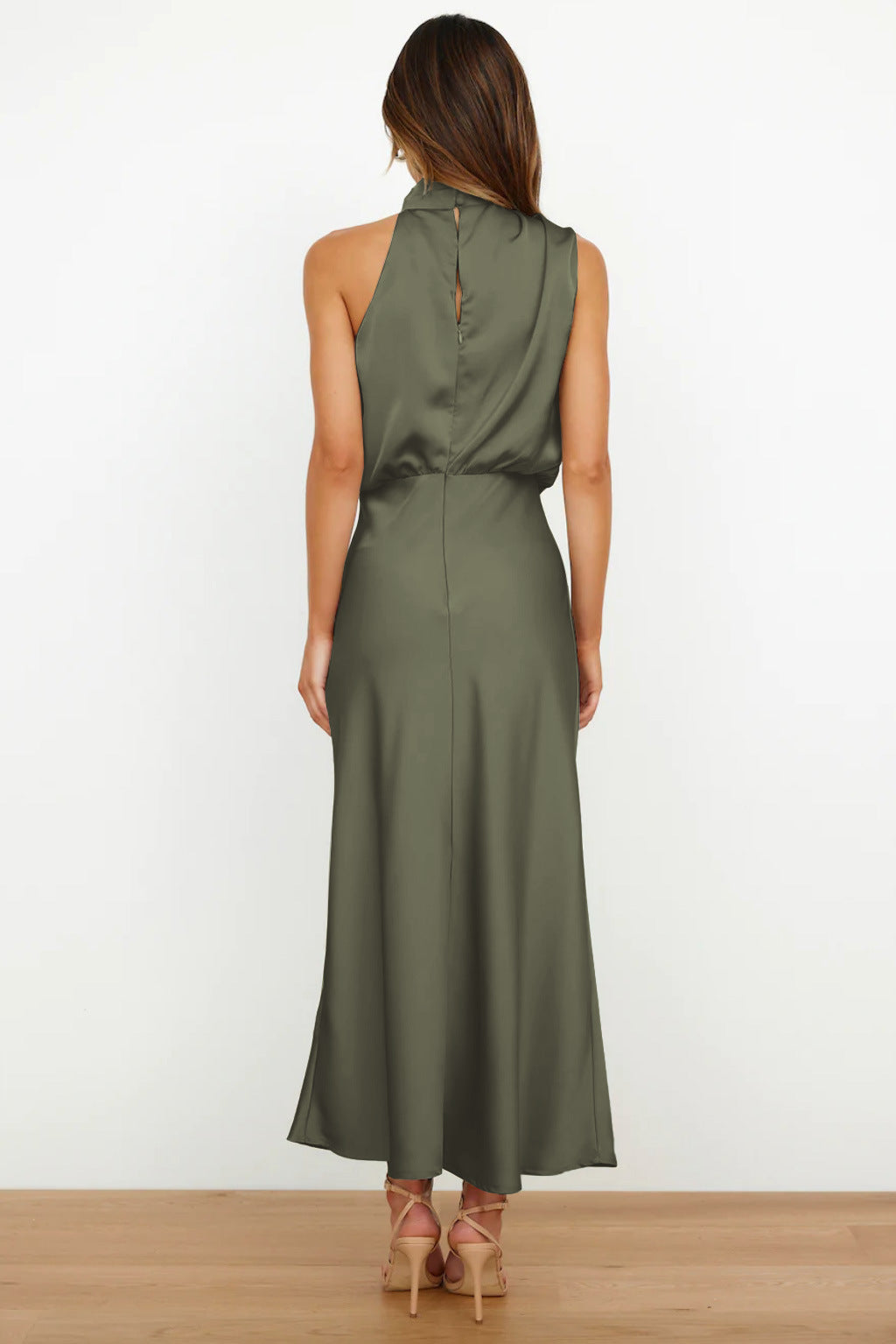 Woman wearing a green dress with a white background