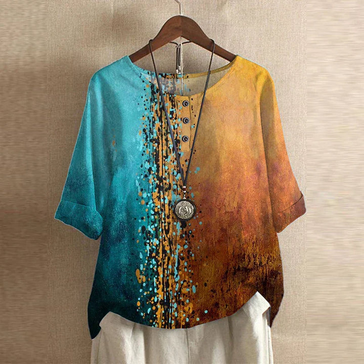 Colorful shirt with gradient design on a hanger against a beige wall