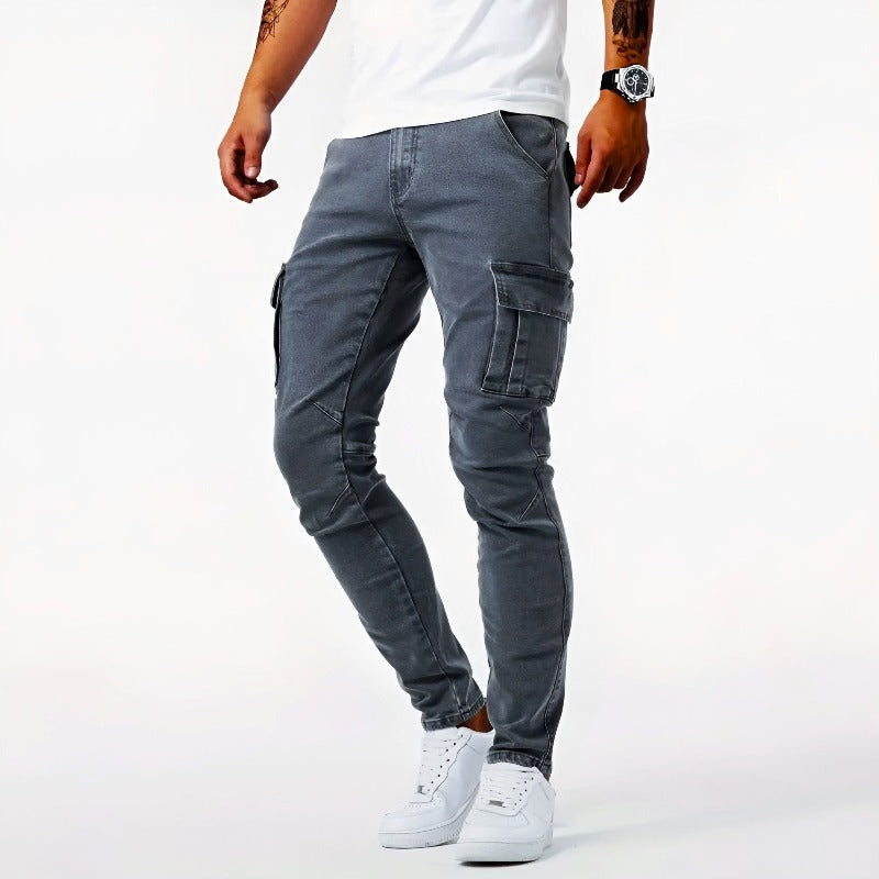 Person wearing gray cargo pants and white sneakers on a white background