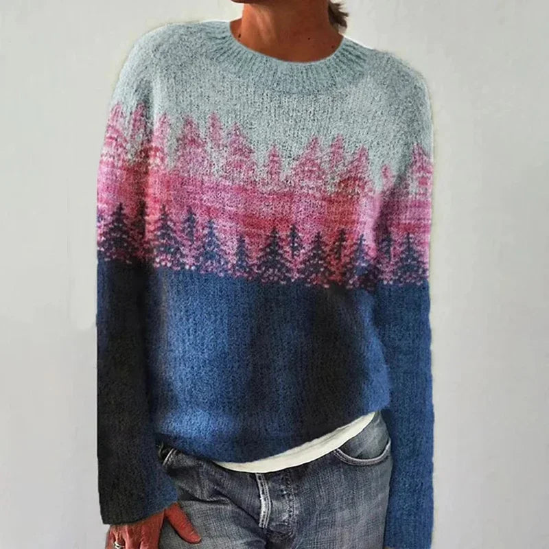 Person wearing a sweater with a colorful pattern on a plain background
