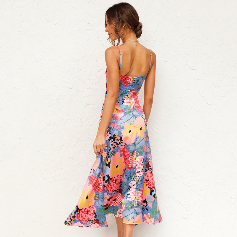 Woman wearing a colorful floral dress against a white background