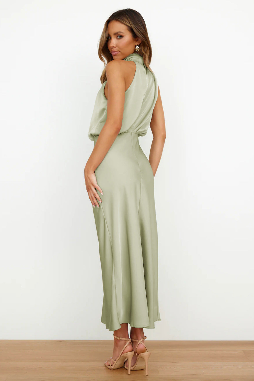 Woman wearing a light green dress on a white background