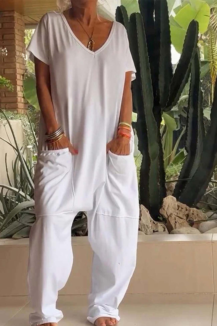 Person wearing a white outfit with cacti in the background