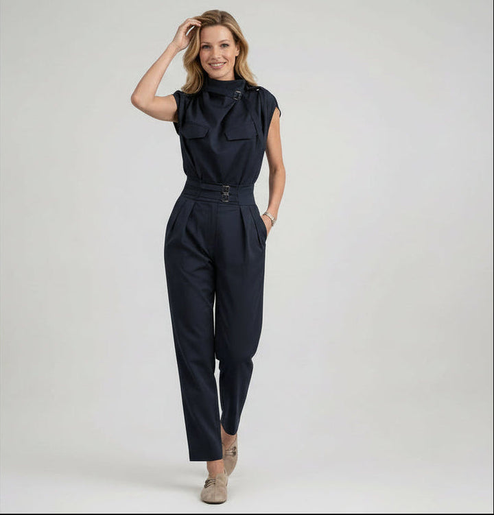Woman wearing a navy blue jumpsuit on a white background