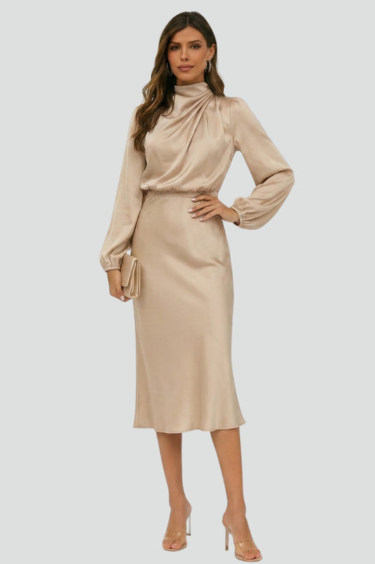 Woman wearing a beige dress with long sleeves on a white background