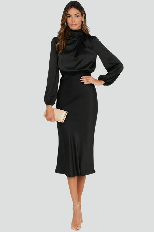 Woman wearing a black dress with long sleeves on a light gray background
