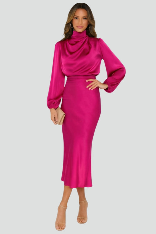 Woman wearing a bright pink dress with long sleeves on a light gray background