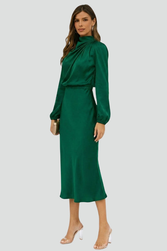 Woman wearing a green dress on a light gray background