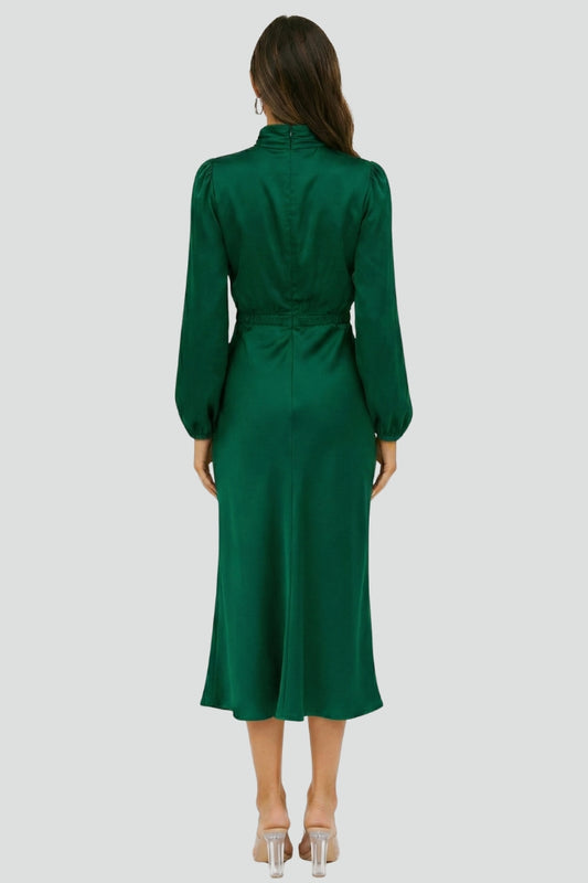 Green dress worn by a model on a light gray background