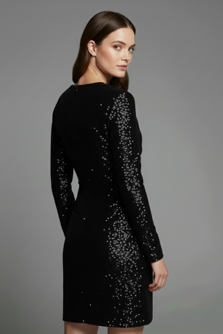 Black sequin dress worn by a model on a gray background