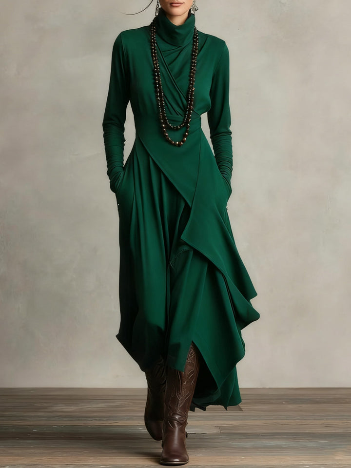 Green dress with long sleeves and layered skirt worn by a model against a neutral background