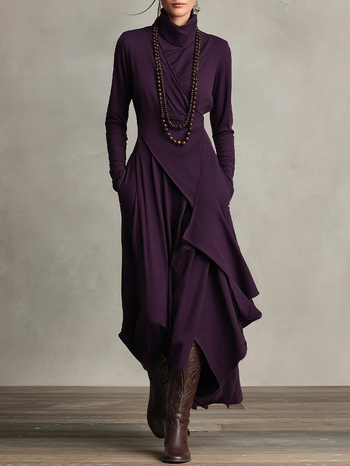 Purple dress with a layered skirt and brown boots on a neutral background