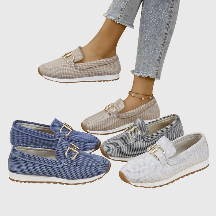 Three pairs of loafers in blue, gray, and beige with gold buckles on a light gray background.