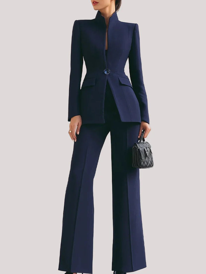 Navy blue suit with a matching handbag on a light gray background