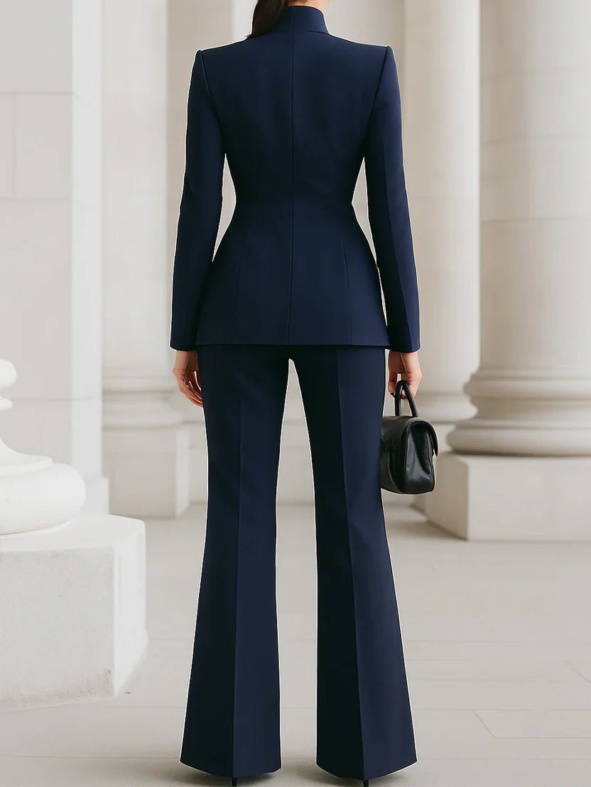 Female model wearing a matching blazer and high-waist pants set against a plain background.